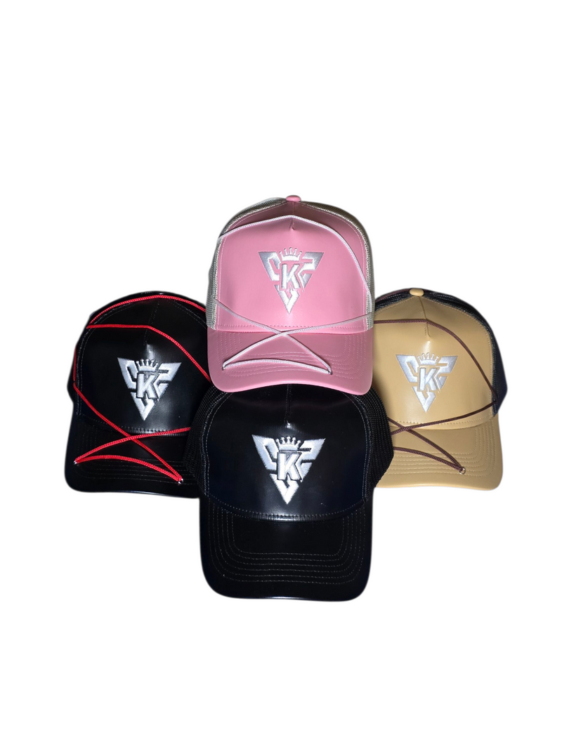 Five baseball caps in black, pink, and beige with a SKZ logo on a white background and includes ropes