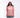 Person wearing a pink 'SKZ' t-shirt and cap on a white background