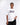 Person wearing a white t-shirt with 'SKZ' logo on a white background