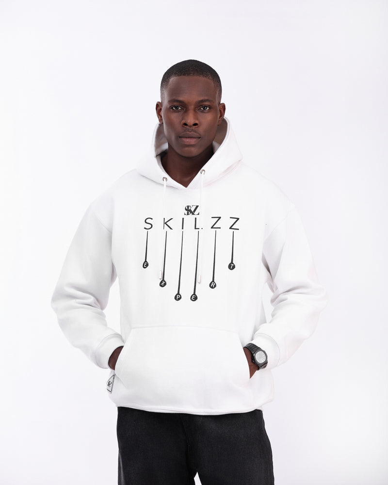 Person wearing a white hoodie with 'SKILZZ' logo while the skilzz is dripping